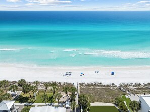 A beach view with a clear sky, a sandy shore, and a few umbrellas. - Seagrove: Private Heated Pool, Casita Incl, Bikes, 3 min walk to Beach (Seagrove Beach)