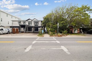 A street view with a building under construction, a tree, and a clear sky. - Seagrove: Private Heated Pool, Casita Incl, Bikes, 3 min walk to Beach (Seagrove Beach)