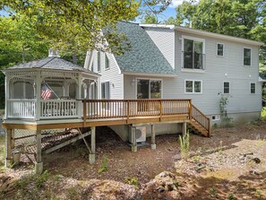 A two-story house with a covered porch and a small gazebo. - Laurel Shores | 3BR/3BA Oceanfront Harpswell Retreat w/ Deck (Harpswell)