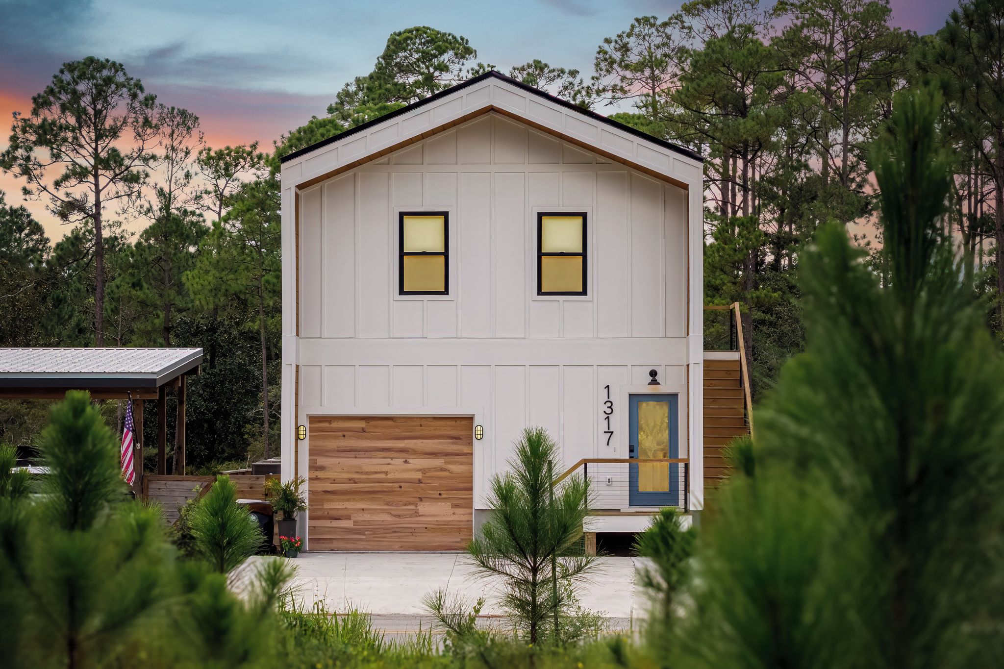 A two-story house with a garage, two windows, and a front door.