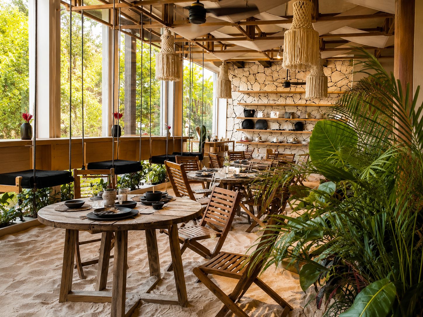 Een restaurant met houten tafels en stoelen, een stenen muur met planken, en macramé verlichting.