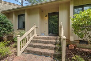A house with a front porch, a brick staircase, and a mailbox.