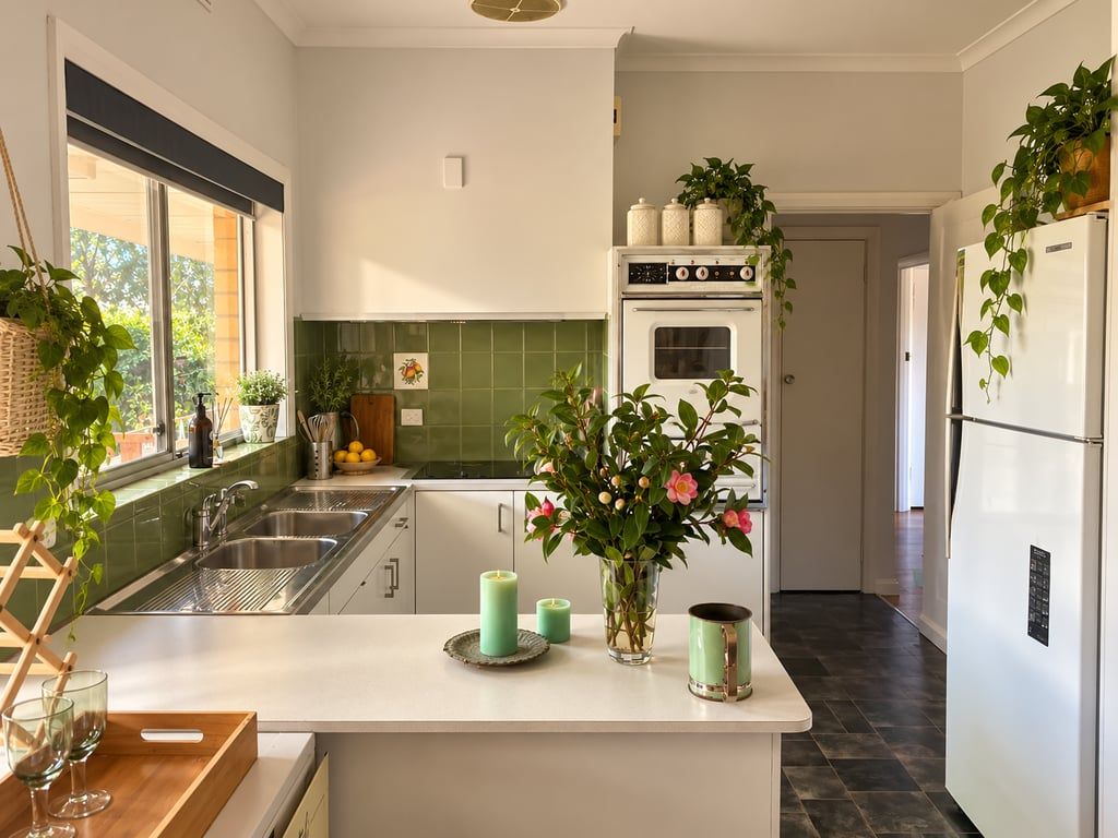 A kitchen with a central island, a built-in oven, and a refrigerator.