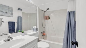 A modern bathroom with a shower, toilet, and sink. - Oceanfront Shore Dr Condo w/ Pools & Beach Access (Myrtle Beach)