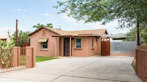 A single-story house with a front door, a small porch, and a fenced yard. - 1945 Adobe in the Heart of Tucson (Tucson)