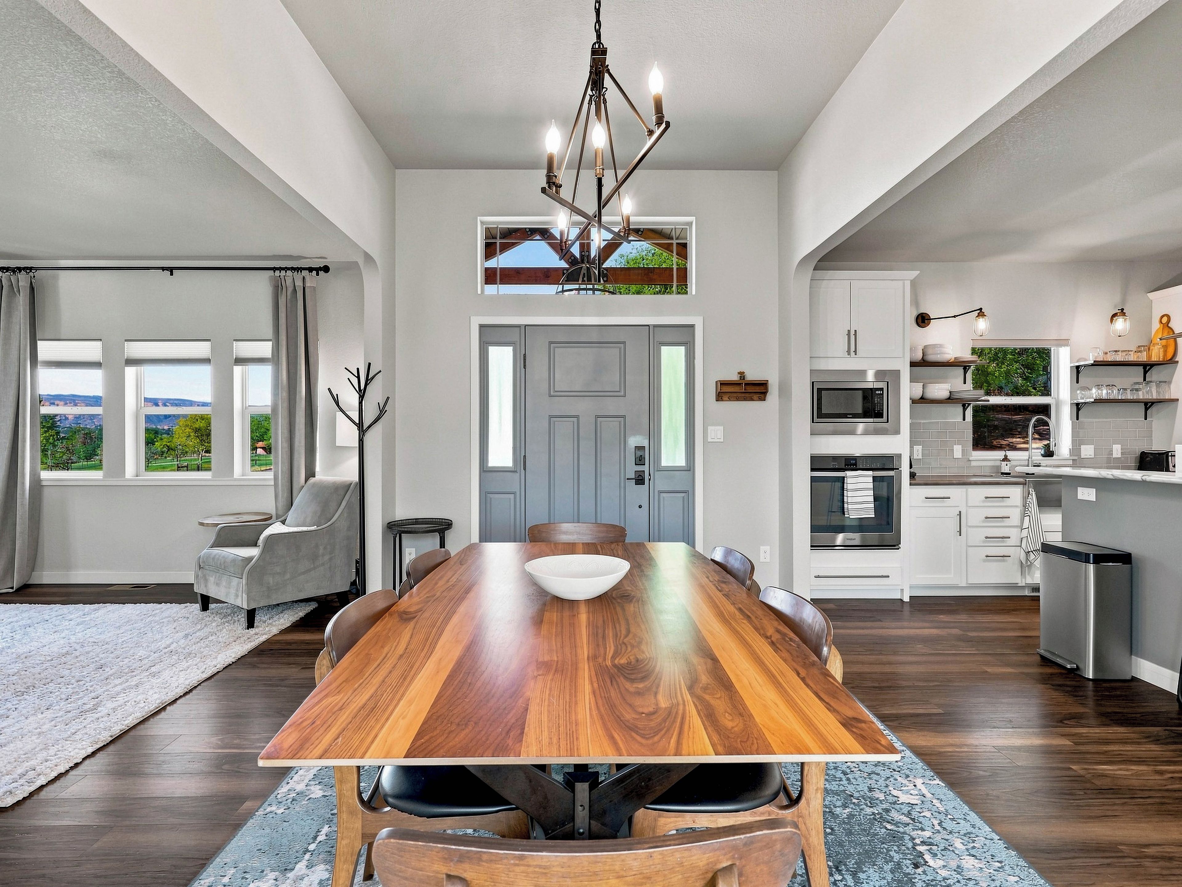 A modern kitchen with a built-in microwave, oven, and stainless steel appliances.