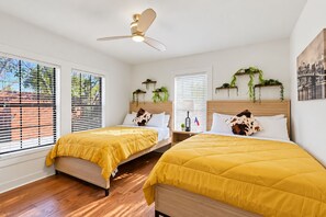 A bedroom with two beds, a ceiling fan, and windows with blinds. - Austin Fun House Huge Private Yard, Pickleball, Cowboy Pool & Hot Tub (Austin)