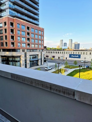 A modern building with a flat roof and a large sign for 'Marshalls.' - Brand New Studio on LRT Line (Toronto)