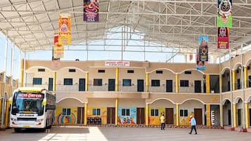 A bus station with a covered waiting area, multiple entry points, and a bus labeled 'Jack Sparrow' in front.
