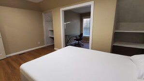 A bedroom with a bed, a door, and a closet. - 2BR/2BA Furnished Home with Theater room, Wi-Fi & RV Parking (El Dorado)