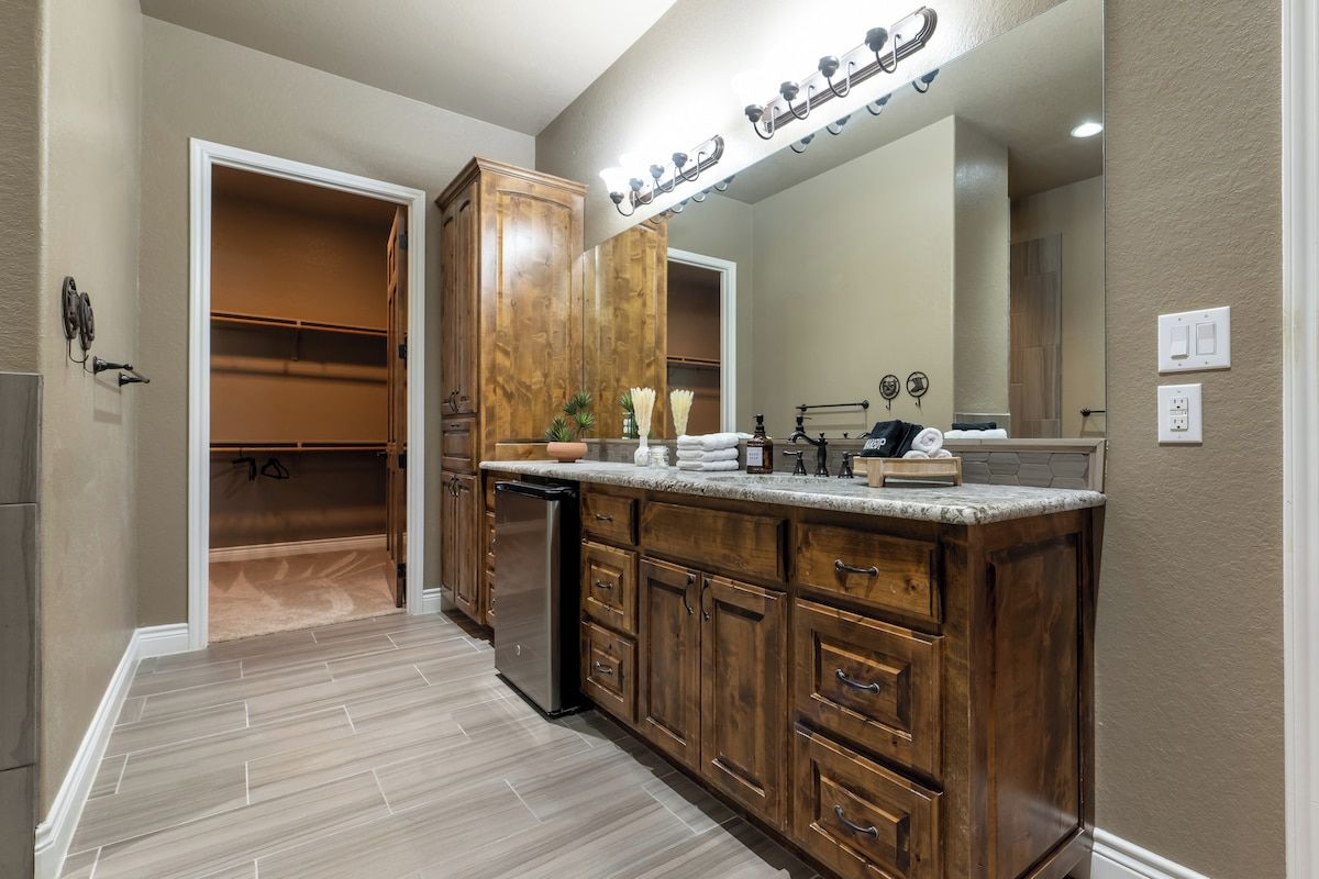 A kitchen with wooden cabinets, a countertop, and a built-in oven.