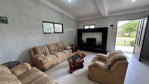 A living room with a sofa set, a coffee table, and a fireplace.