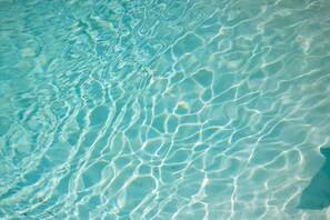 A close-up of clear, shallow water with visible ripples and patterns. - The Pearl Retreat (Nashville)