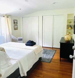 A bedroom with a bed, a dresser, a nightstand, and a wardrobe. - Peaceful Retreat with Massive Private Deck – Free Parking & Easy Highway Access (Vestal)