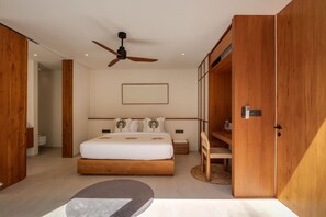 A modern bedroom with a large bed, wooden wardrobe, ceiling fan, and a bedside table. - NEW 4BR Luxury Family Villa with Pool in Bingin (South Kuta)
