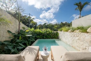 A pool with lounge chairs and a stone wall. - Chianti 2BR Luxury Villa in the Heart of Bingin (South Kuta)