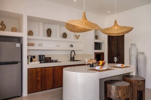 Een moderne keuken met een centraal eiland, houten kastjes en een ingebouwde oven.