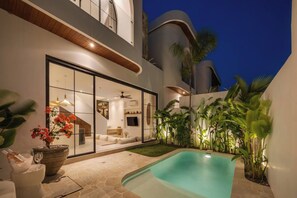 A modern house with a swimming pool, a glass-enclosed patio, and tropical plants. - Kaia 1BR Villa in the Heart of Bingin, Uluwatu (South Kuta)