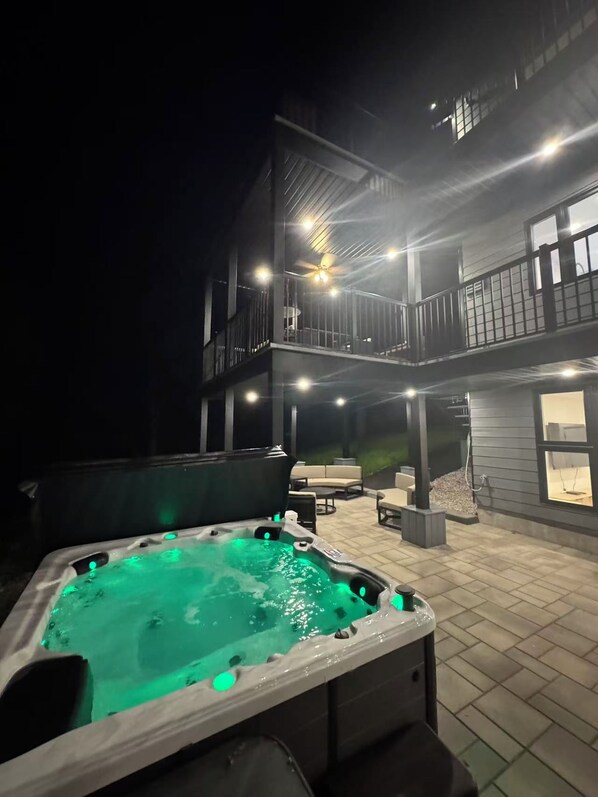 A hot tub in an outdoor area with a building in the background.