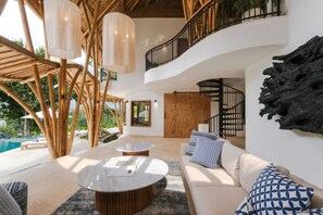 A modern interior with a pool, outdoor seating, and a staircase. - Ahura 5BR Oceanview in Bingin Uluwatu (Kecamatan Kuta Selatan)