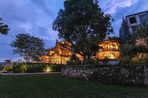 A large, modern building with a unique architectural design, surrounded by lush greenery. - Ahura 5BR Oceanview in Bingin Uluwatu (Kecamatan Kuta Selatan)