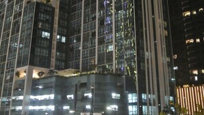 A high-rise building with multiple floors, large windows, and a modern architectural design. - One Uptown Residence BGC Modern BGC Home | 300Mbps + Workspace (Makati City)
