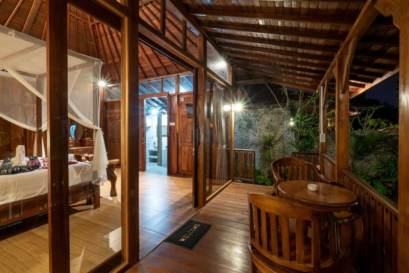 A wooden interior with a bed, a table, and a bench.
