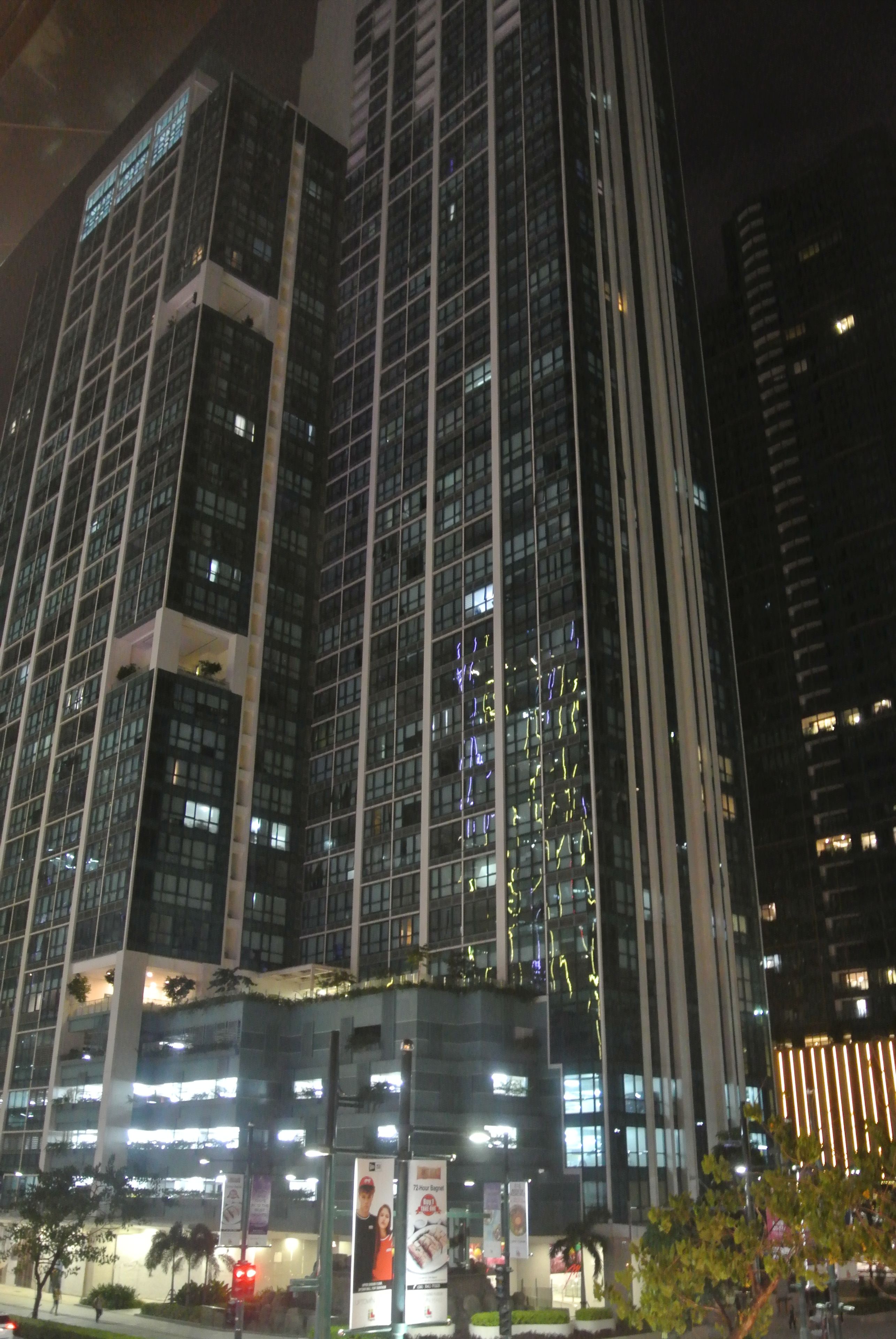 A high-rise building with multiple floors and large windows.