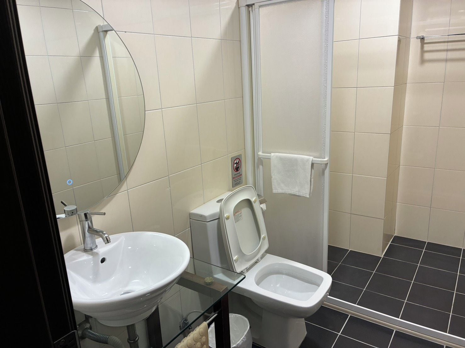A bathroom with a sink, toilet, and shower.