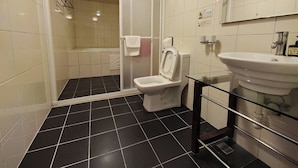 A modern bathroom with a glass shower enclosure, a white toilet, a glass sink, and a mirror. - Hub Hotel Chiayi (Chiayi)