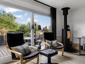 A balcony with two chairs, a table, and a fireplace. - "Efrosina" - 600m from the sea by Interhome (Hejls)
