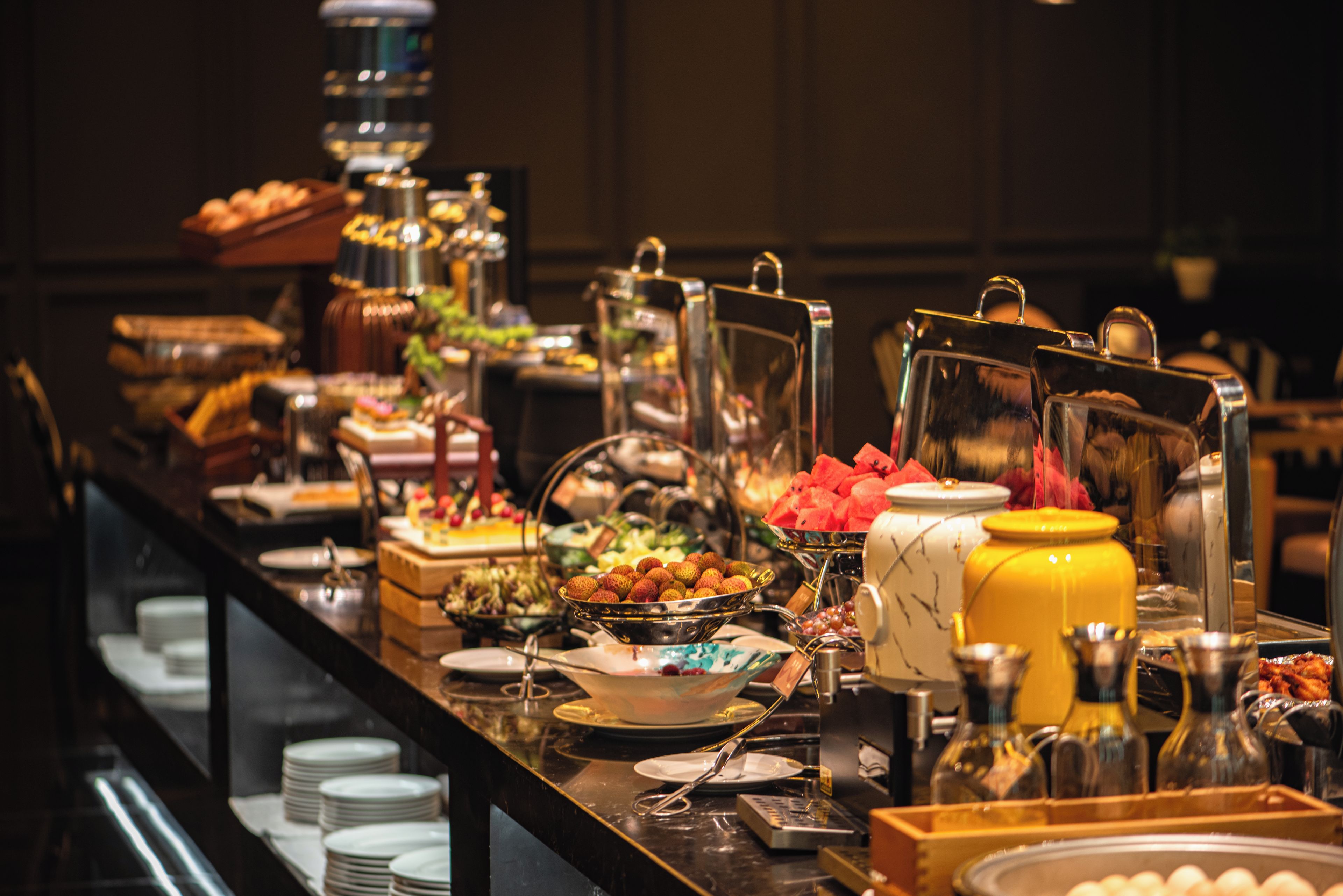 A buffet with various food items and serving utensils.