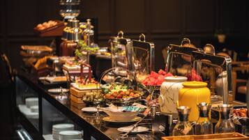 A buffet with various food items and serving utensils.