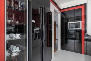 A modern kitchen with a glass door refrigerator, a microwave, and a Samsung oven.
