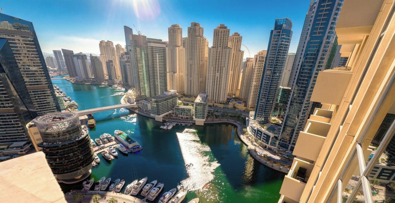 A high-rise building with a marina and waterway.