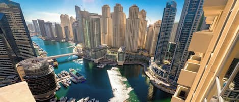 A high-rise building with a marina and waterway.