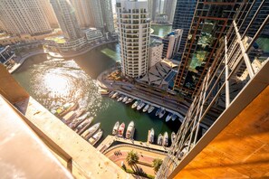 A high-rise building with a marina and boats docked in front. - The Classic • JW Marriott (Dubai)
