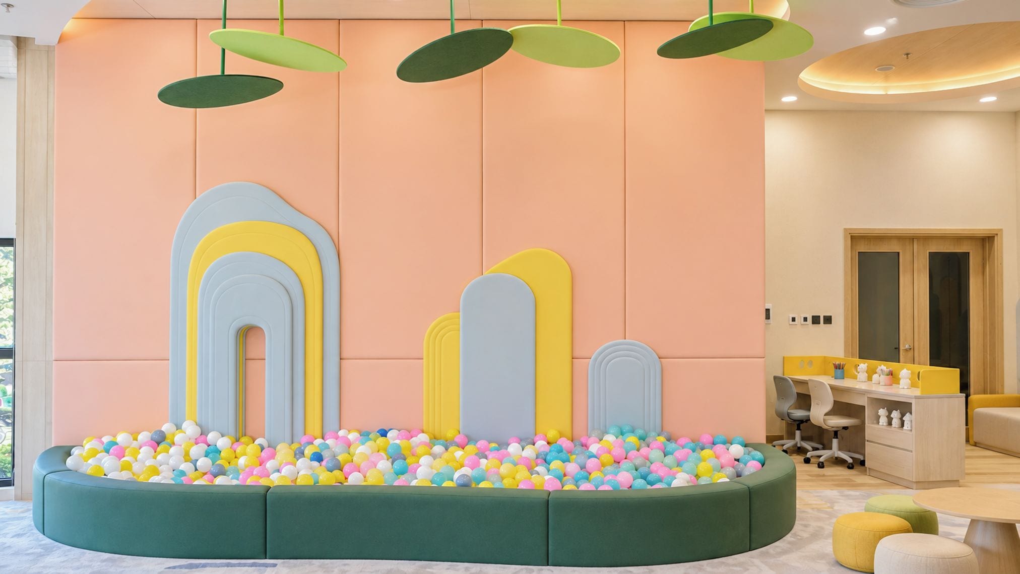 A children's play area with colorful balls and a soft seating area.