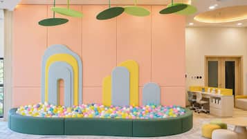 A children's play area with colorful balls and a soft seating area.