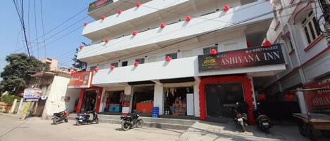A multi-story building with a hotel named 'Ashiyana Inn' on the ground floor.