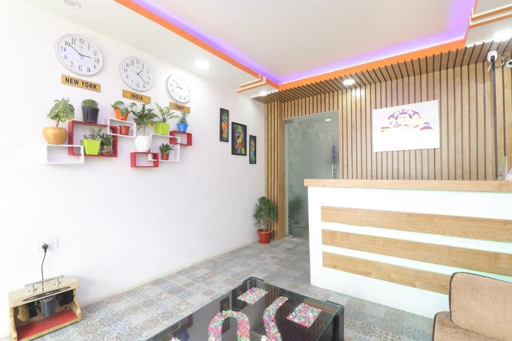 A reception area with a wooden reception desk, multiple clocks on the wall, and potted plants.