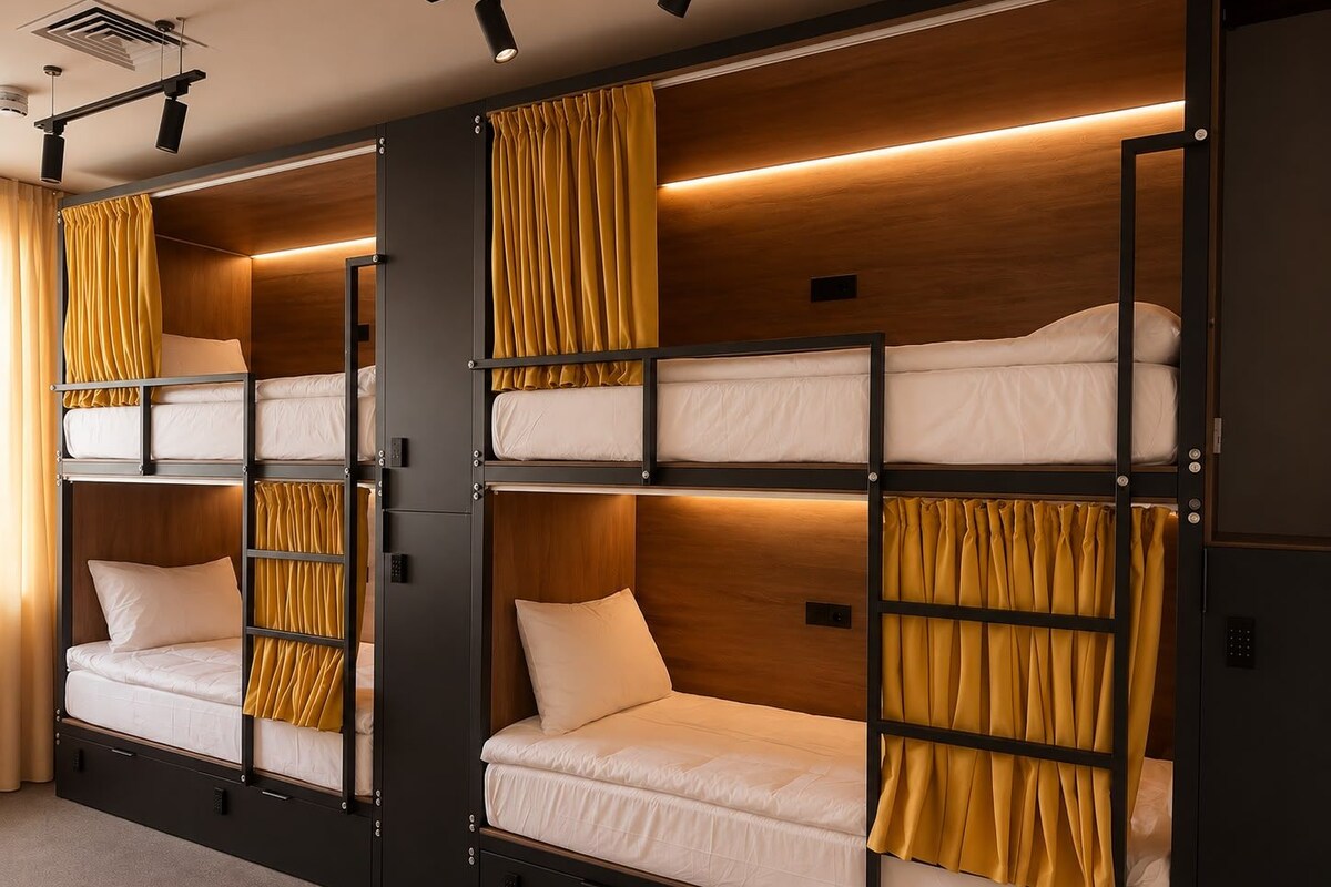 A bunk bed room with a wooden finish, curtains, and a ceiling light.