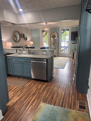 A modern kitchen with a central island, built-in appliances, and a view to the dining area.