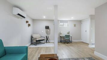 Un salon moderne comprenant un canapé, une table basse et un coin repas avec une table et des chaises.