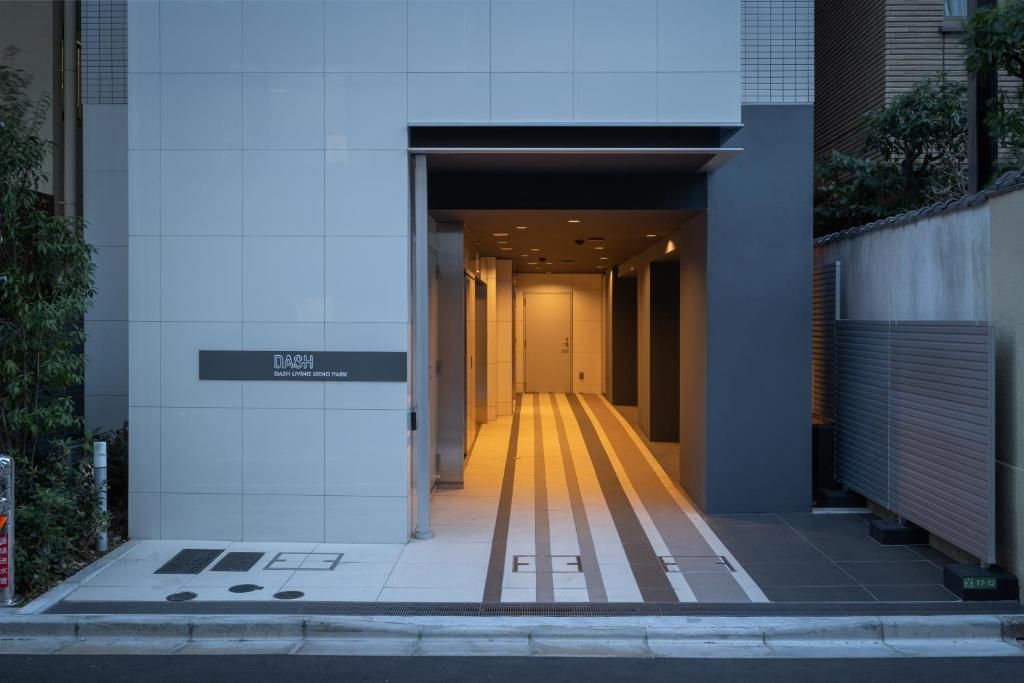 A modern building entrance with a sign reading 'DASH BABY LIVING DINING PARK'.