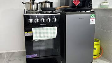 A kitchen with a stove, oven, microwave, and a Hisense refrigerator.