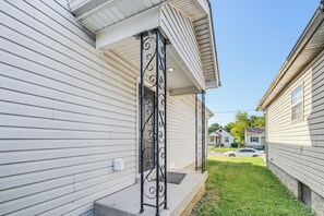 A residential property with a front porch and a small front yard. - Derby House (Louisville)