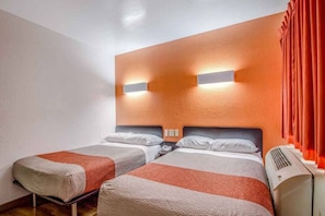 A hotel room with two beds, a wall-mounted air conditioner, and a red curtain. - Cozy 2-Bed Room|Pool|Free Parking (Conroe)