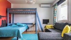 A room with a bunk bed, a sofa, a small table, and a window with curtains. - Viinijärvi d 10 by Interhome (Liperi)