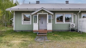 A single-story house with a front porch, a chimney, and a small front yard. - Viinijärvi d 10 by Interhome (Liperi)
